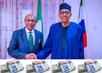 Nigeria's Central Bank governor, Godwin Emefiele in an handshake with President Muhammadu Buhari with Nigeria's new currency notes in front of them.