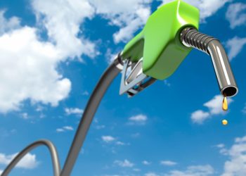 Petrol dripping out of a green fuel nozzle