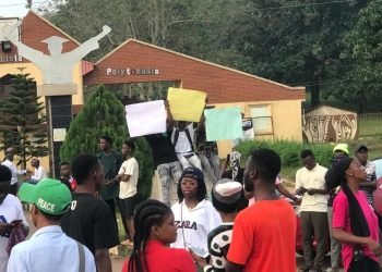 Mapoly students in front of the school gate.
