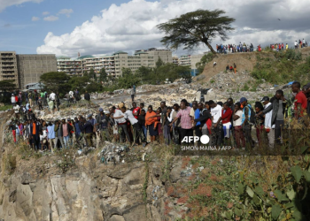 People look into a dumpsite where mutilated bodies of 9 women were discovered in Kenya