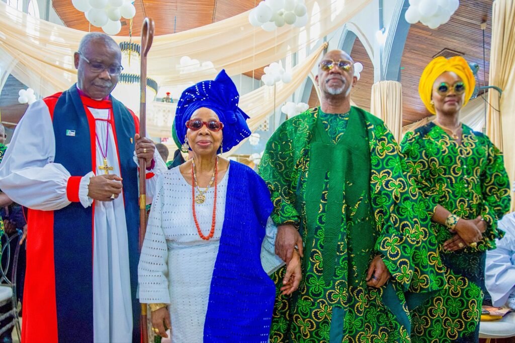A clergy with Dapo Abiodun's mother, Dapo Abiodun and wife at Dapo Abiodun's mother 90th birthday party in Iperu.