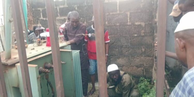 Ijagun Road CDA members at the IBEDC transformer whose cable were vanderlisized.