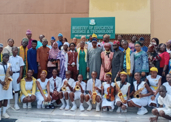 The Commissioner for Education, Science and Technology, Prof Abayomi Arigbabu in group photograph with 16-year-old one-day Comissioner and SS3 student of African Grammar School, Ita Iyalode, Abeokuta, Alaka Oluwagbemisoke alongside other students of the school and officials of the ministry. Credit: Taiwo Bankole: